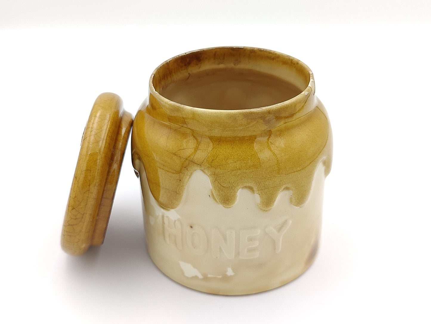 This adorable honey pot jar was handmade in Portugal in 1982. It has some crazing on the lid as well on the jar and has a cork plugging a hole. It reminds me of Winnie the Pooh! It stands 5" tall and approximately 4" in diameter. Weighs 1 lb 3.8oz.