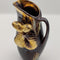 Powdered copper pitcher painted with bronze and chestnuts and leafs* attached on the side. It stands approximately 8.5" tall and 4.5" wide, about 3" long.. weighing 1 lb 1.1oz.