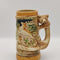 The item depicted is a vintage German-style beer stein,  made in Japan. Features a fox handle and the German phrase &quot;Des Jägers Freud,&quot; which translates to &quot;The Hunter&#39;s Joy.&quot; . It has a bear on/as the handle