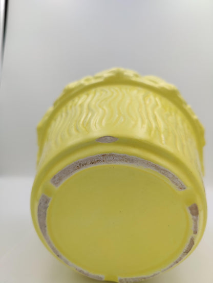 Light yellow mid sized planter has semi-thin vertical textured waves along face sides of the circular planter. 2&quot; seashells ring around the lip. Stands about 6.5&quot; H 8&quot; D. few small noticable dings and one 1 inch..small chip on bottom